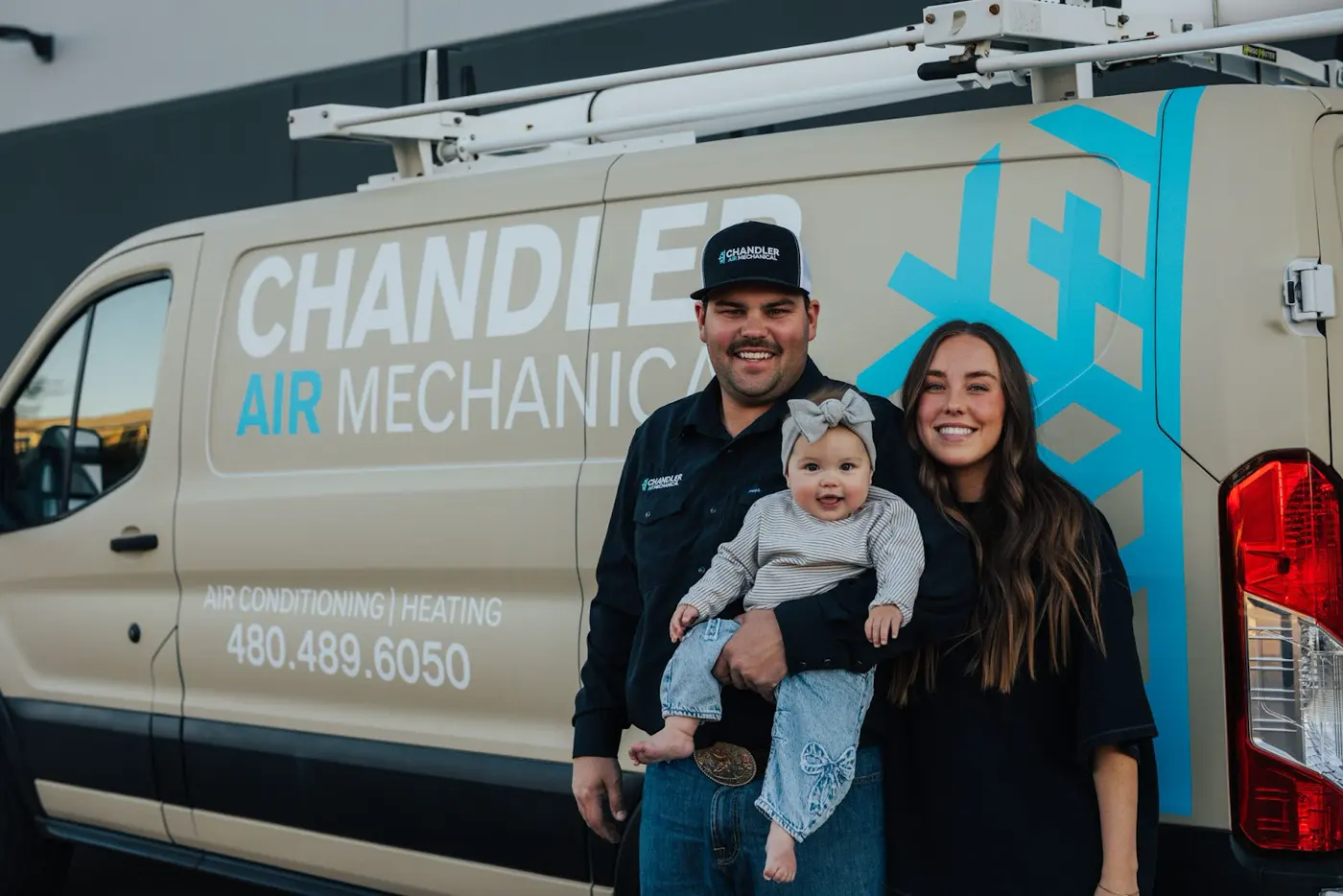 The Chandler Air Mechanical owner and his family beside a company van