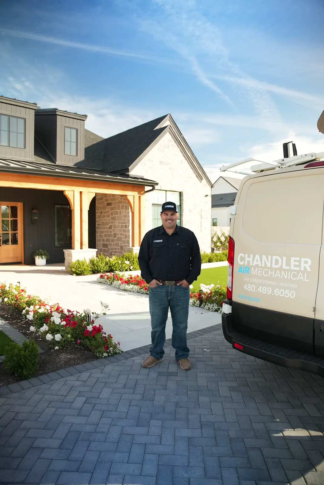 Chandler Air Mechanical owner standing beside the company van outside a customer's home